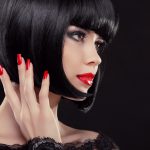 Bob short black hairstyle. Manicured nails and red lips. Fashion
